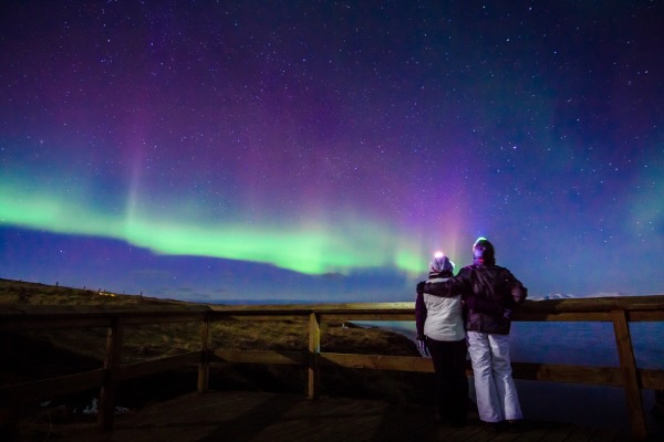 A couple in Iceland in front of the Northern Lights
